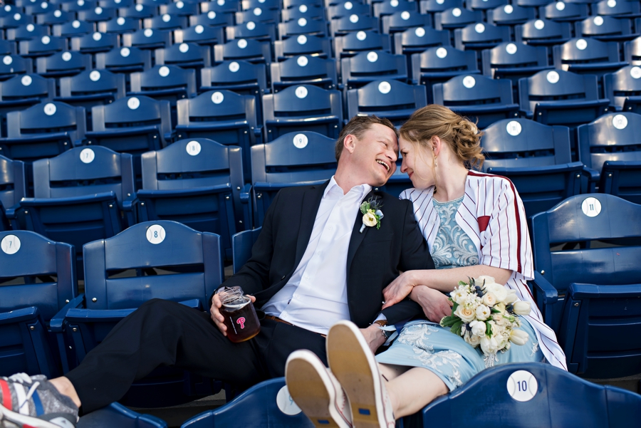 A newly married couple enjoy a moment after the ceremony at a Phillies game.